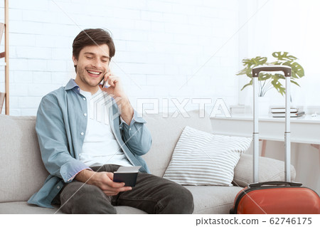 Happy man calling taxi and holding passport Happy man calling taxi and holding passport 62746175