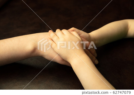Close up of female and kid's hands doing things together, family, home concept Close up of female and kid's hands doing things together, family, home concept 62747079