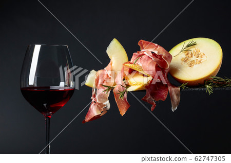 Red wine with prosciutto and melon. Red wine with prosciutto and melon. 62747305