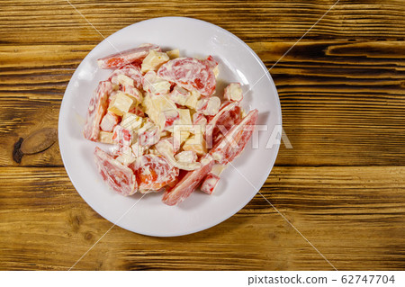 Tasty salad with crab sticks, cheese, tomato 62747704