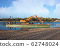 Excavator for channel dredge on a barge. 62748024