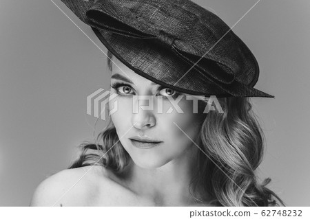 Stunning lady with natural makeup in black hat. 62748232