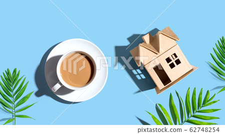 Cardboard house with a cup of coffee Cardboard house with a cup of coffee 62748254