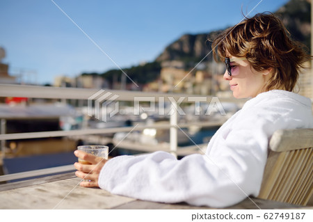 Young charming woman wearing in white terry robe 62749187