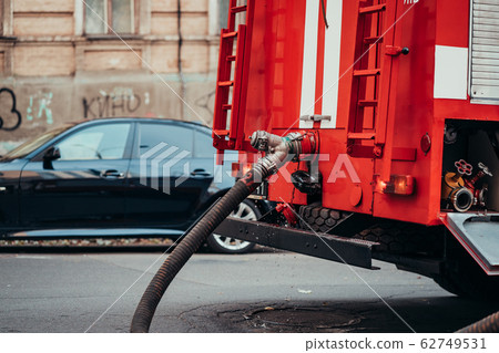 Hoses to quench the fire connecting with water pump valves of fire truck 62749531