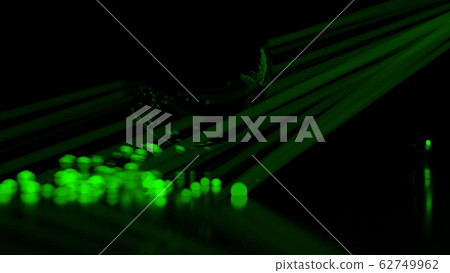 Abstract stream of spherical particles reflected from a large black circular sphere. Paricles are glowing green and have different brightness. 3d illustration with copyspace 62749962