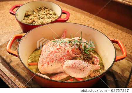 Top view of a raw chicken with stuffing in a pot Top view of a raw chicken with stuffing in a pot 62757227