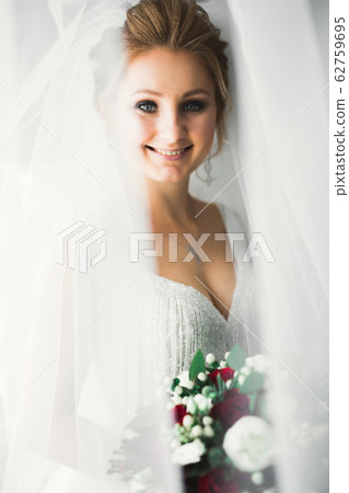Bride holding big and beautiful wedding bouquet with flowers 62759695
