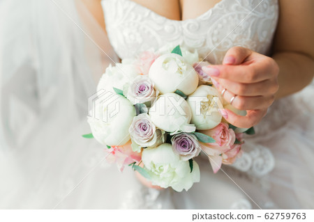 Portrait of stunning bride with long hair posing with great bouquet Portrait of stunning bride with long hair posing with great bouquet 62759763