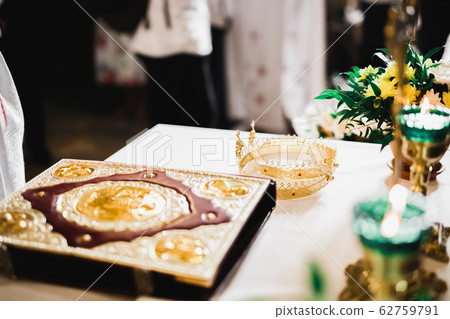 Golden crowns lying on the table in church Golden crowns lying on the table in church 62759791