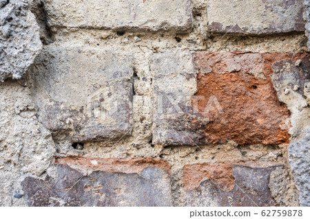 Texture of an old brick wall with crumbling plaster. 62759878