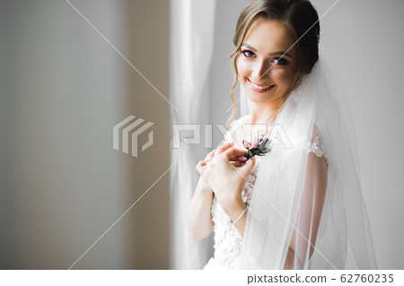 Portrait of stunning bride with long hair posing with great bouquet Portrait of stunning bride with long hair posing with great bouquet 62760235