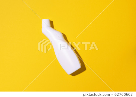 White plastic bottle of cleaning product, household chemicals or liquid laundry detergent on yellow background. Top view. Flat lay. Copy space. Detergent bottle White plastic bottle of cleaning product, household chemicals or liquid laundry detergent on yellow background. Top view. Flat lay. Copy space. Detergent bottle 62760602