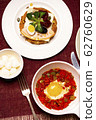 A dish of the fried egg with the stewed peppers. Top view. 62760629
