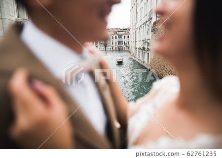 Gorgeous happy couple standing close to each other and looking in eyes 62761235
