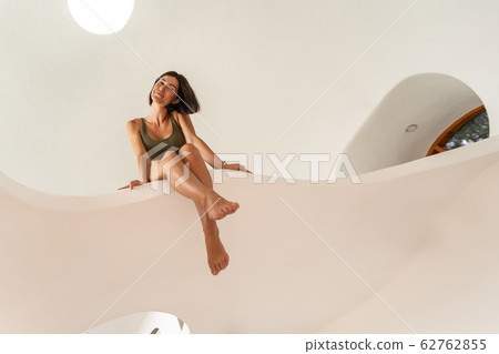 Attractive tanned woman posing for the camera Attractive tanned woman posing for the camera 62762855
