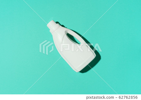 White plastic bottle of cleaning product, household chemicals or liquid laundry detergent on blue background. Top view. Flat lay. Copy space. Detergent bottle White plastic bottle of cleaning product, household chemicals or liquid laundry detergent on blue background. Top view. Flat lay. Copy space. Detergent bottle 62762856