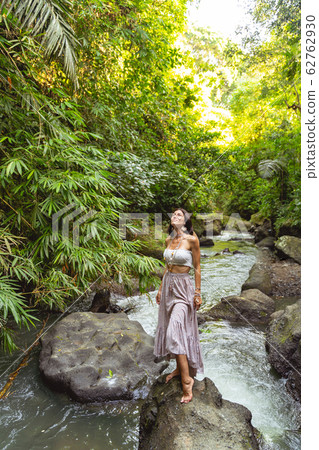 Happy female walking in wild forest stock photo Happy female walking in wild forest stock photo 62762930