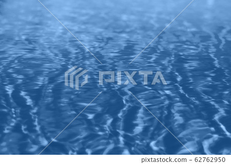 Close up abstract water texture. Swimming pool water in monochrome color background. Trendy blue and calm color. Copy space, top view. 62762950