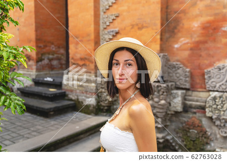 Happy woman travelling through asia stock photo Happy woman travelling through asia stock photo 62763028