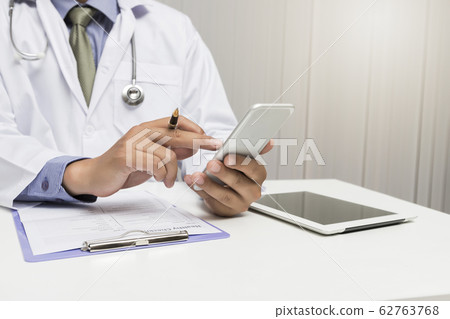 Medic working with modern smart phone Medic working with modern smart phone 62763768