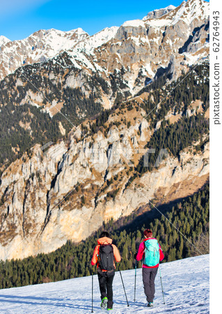 Girl friends during a winter hike on the snow in Girl friends during a winter hike on the snow in 62764943