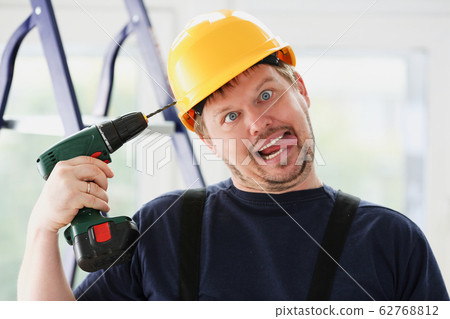 Idiot worker using electric drill portrait 62768812