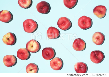 Peaches pattern on pastel blue background. Frame made of fresh fruits. Flat lay, top view, copy space. Vegan and vegetarian diet 62769743
