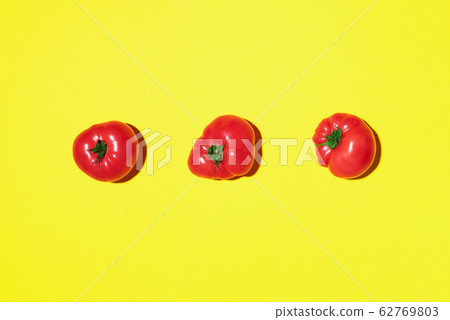 Red tomatoes pattern on yellow background. Flat lay, top view. Summer minimal concept. Vegan and vegetarian diet Red tomatoes pattern on yellow background. Flat lay, top view. Summer minimal concept. Vegan and vegetarian diet 62769803