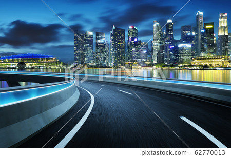 Highway overpass modern Singapore city skyline background . Night scene . Highway overpass modern Singapore city skyline background . Night scene . 62770013