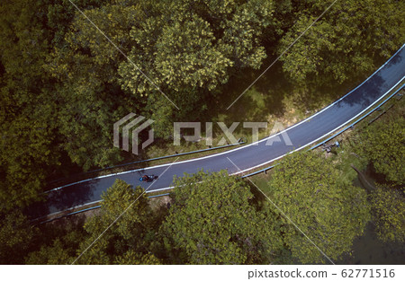 Aerial view of the forest on country road motorcycle rider , Malaysia . Aerial view of the forest on country road motorcycle rider , Malaysia . 62771516