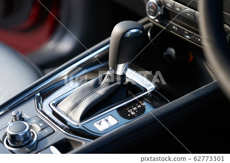 Vehicle interior of a modern car with media and navigation control buttons 62773301