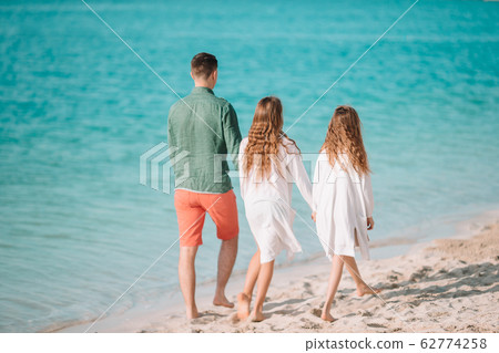 Father and little kids on the beach 62774258