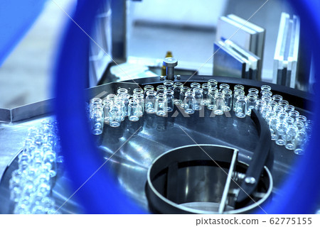 pharmaceutical industry. Production line machine conveyor at factory with bottles pharmaceutical industry. Production line machine conveyor at factory with bottles 62775155