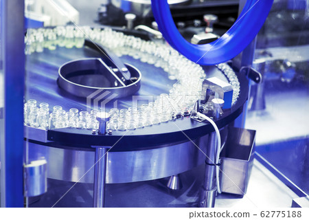 pharmaceutical industry. Production line machine conveyor at factory with bottles pharmaceutical industry. Production line machine conveyor at factory with bottles 62775188