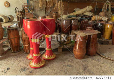 The long drum is painted red and golden. The long drum is painted red and golden. 62775514