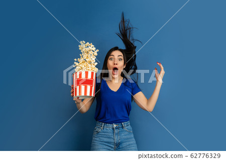 Caucasian woman's portrait isolated on blue studio background Caucasian woman's portrait isolated on blue studio background 62776329