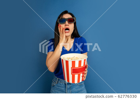 Caucasian woman's portrait isolated on blue studio background Caucasian woman's portrait isolated on blue studio background 62776330