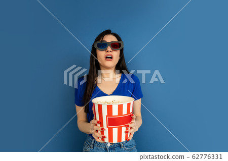 Caucasian woman's portrait isolated on blue studio background Caucasian woman's portrait isolated on blue studio background 62776331