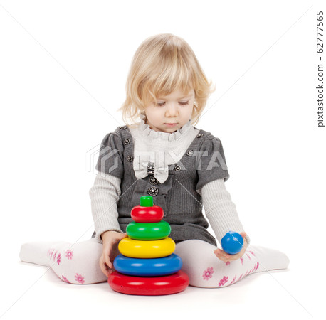 Baby girl with a toy pyramid 62777565