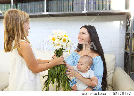 Little girl giving bouquet of beautiful flowers to Little girl giving bouquet of beautiful flowers to 62778157