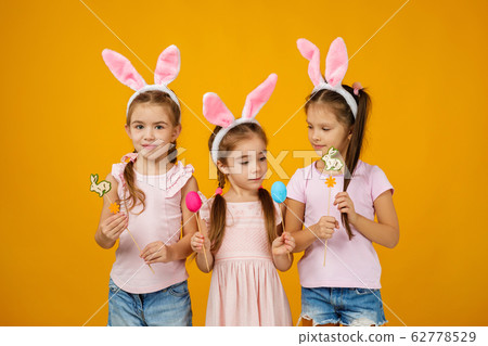 child girls holding painted Easter eggs 62778529