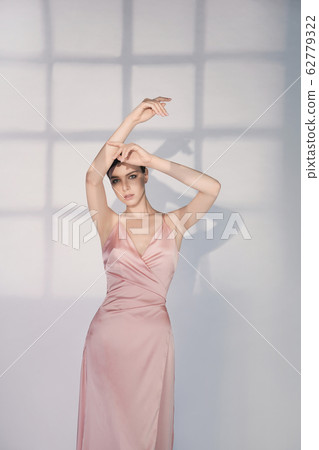 Beautiful woman pose in studio in pink classic Beautiful woman pose in studio in pink classic 62779322