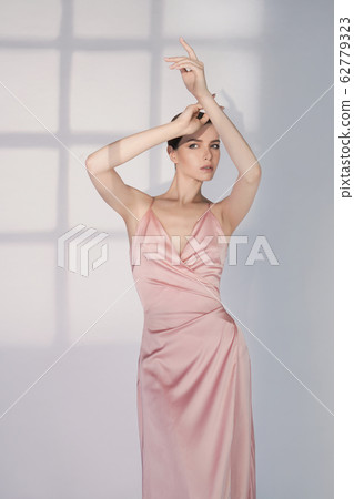 Beautiful woman pose in studio in pink classic Beautiful woman pose in studio in pink classic 62779323