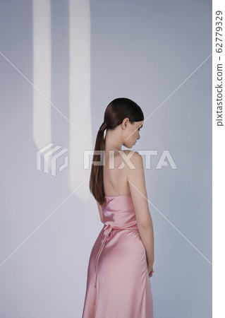 Beautiful woman pose in studio in pink classic Beautiful woman pose in studio in pink classic 62779329