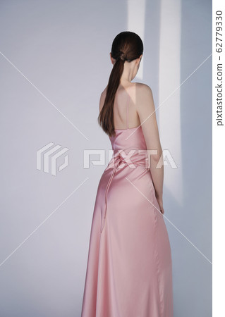 Beautiful woman pose in studio in pink classic Beautiful woman pose in studio in pink classic 62779330