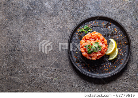 Raw salmon, avocado purple onion salad served in 62779619