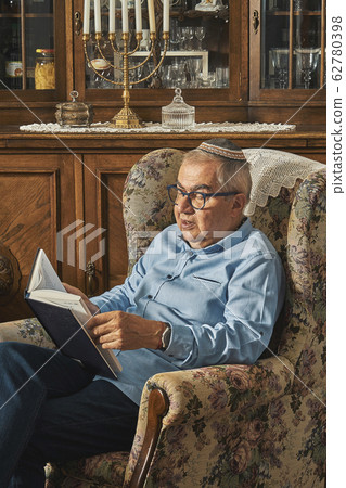 Senior Jew reading book in traditional home Senior Jew reading book in traditional home 62780398