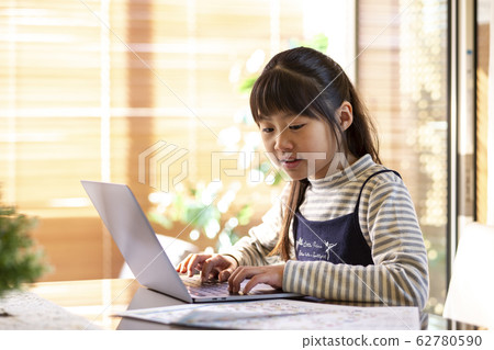Elementary school girl typing Elementary school girl typing 62780590