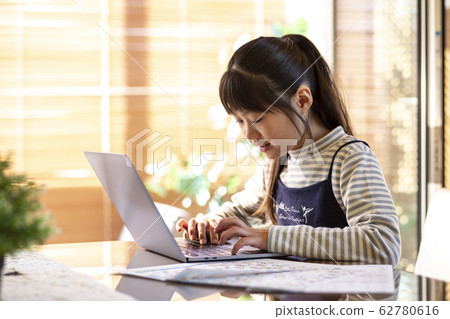 Elementary school girl typing 62780616